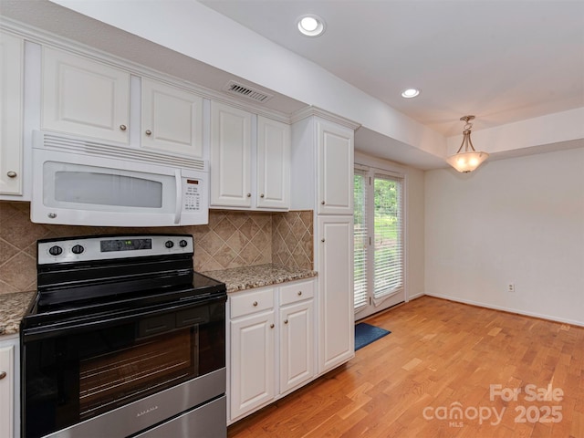 4025 Woodfox Dr, Charlotte, NC 28277 - kitchen with white microwave, electric range, white cabinetry, backsplash, and light stone counters