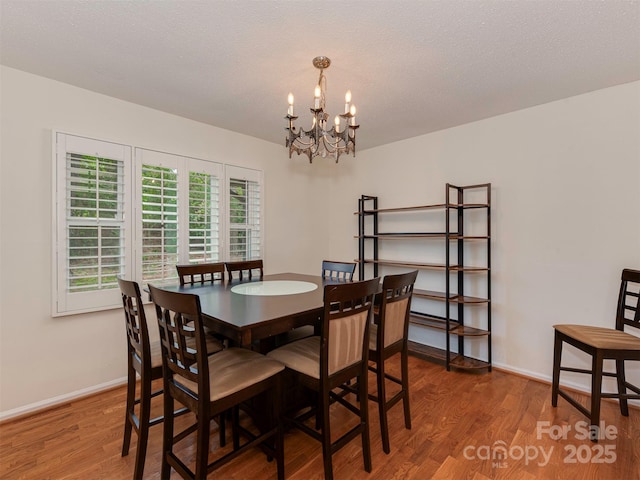 4025 Woodfox Dr, Charlotte, NC 28277 - dining area with a chandelier, wood finished floors, and baseboards