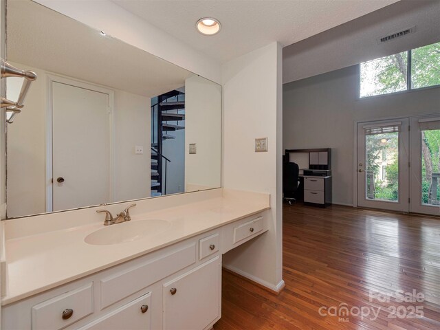 4025 Woodfox Dr, Charlotte, NC 28277 - bathroom featuring wood finished floors, baseboards, vanity, and recessed lighting