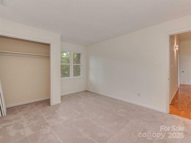 4025 Woodfox Dr, Charlotte, NC 28277 - unfurnished bedroom with carpet flooring, baseboards, and a closet