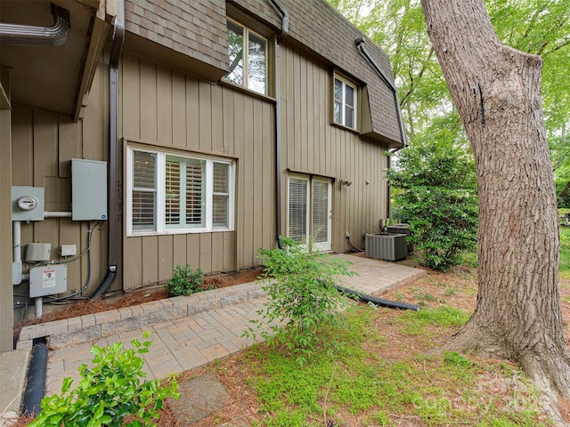 4025 Woodfox Dr, Charlotte, NC 28277 - back of house featuring roof with shingles, central AC unit, a patio, and mansard roof