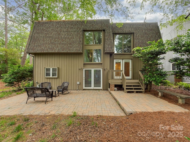 4025 Woodfox Dr, Charlotte, NC 28277 - rear view of house with roof with shingles, a patio, mansard roof, and a wooden deck