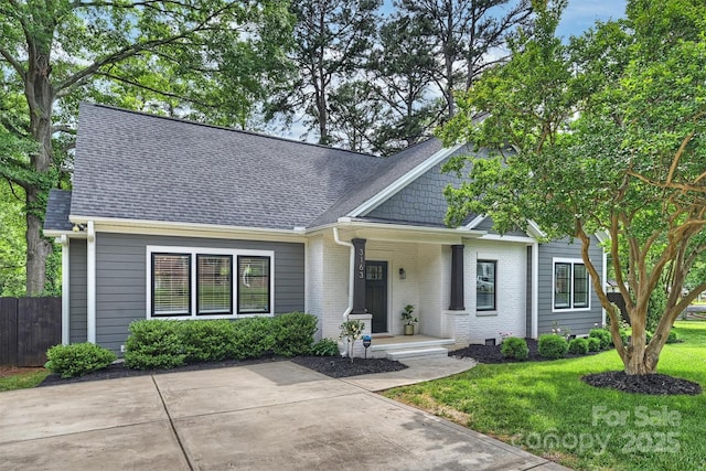 3163 Maury St, Charlotte, NC 28208 - view of front of property featuring roof with shingles, brick siding, and covered porch