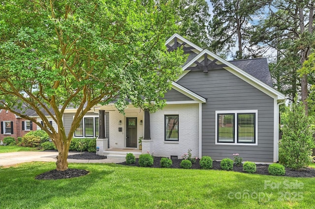 3163 Maury St, Charlotte, NC 28208 - view of front of house featuring a front lawn, brick siding, and roof with shingles