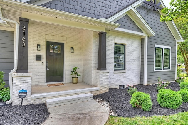 3163 Maury St, Charlotte, NC 28208 - doorway to property featuring brick siding, a porch, and crawl space