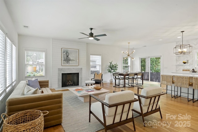 3163 Maury St, Charlotte, NC 28208 - living area featuring a chandelier, a fireplace with flush hearth, light wood finished floors, ceiling fan, and recessed lighting