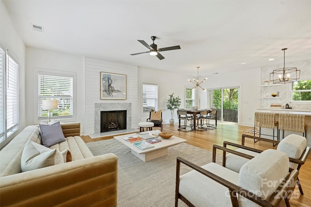 3163 Maury St, Charlotte, NC 28208 - living area with a chandelier, light wood-type flooring, healthy amount of natural light, a fireplace, and recessed lighting