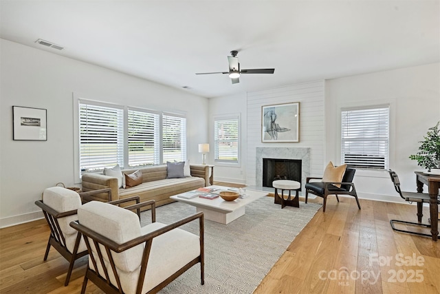 3163 Maury St, Charlotte, NC 28208 - living area featuring light wood finished floors, ceiling fan, baseboards, and a fireplace