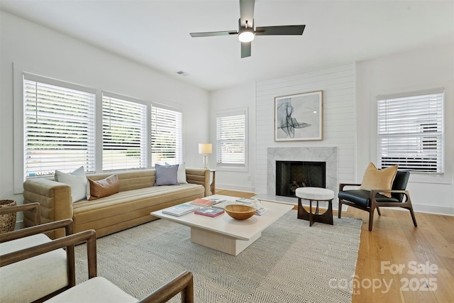 3163 Maury St, Charlotte, NC 28208 - living room with light wood-style floors, ceiling fan, a high end fireplace, and baseboards
