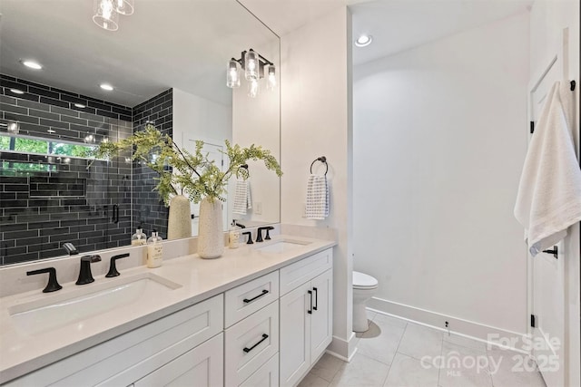 3163 Maury St, Charlotte, NC 28208 - bathroom with tile patterned floors, toilet, double vanity, tiled shower, and baseboards
