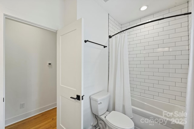 3163 Maury St, Charlotte, NC 28208 - bathroom with shower / bathtub combination with curtain, wood finished floors, toilet, and baseboards