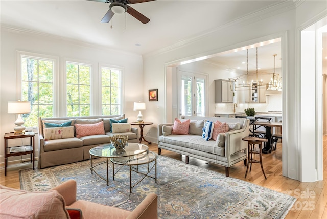 20 E Owl Creek Ln, Fairview, NC 28730 - living area with ornamental molding, a ceiling fan, light wood-style floors, a chandelier, and baseboards