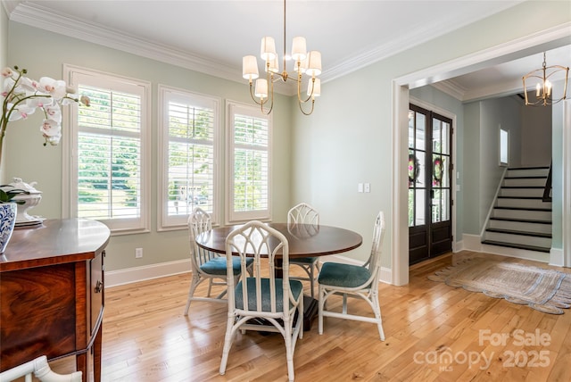 20 E Owl Creek Ln, Fairview, NC 28730 - dining space with a chandelier, light wood finished floors, baseboards, crown molding, and stairs