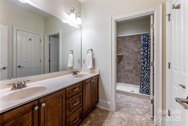 20 E Owl Creek Ln, Fairview, NC 28730 - bathroom with double vanity, a tile shower, tile patterned flooring, and baseboards