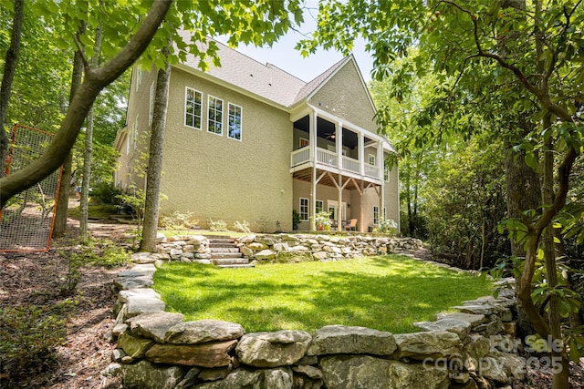 20 E Owl Creek Ln, Fairview, NC 28730 - rear view of house featuring stucco siding, a balcony, a yard, and a shingled roof
