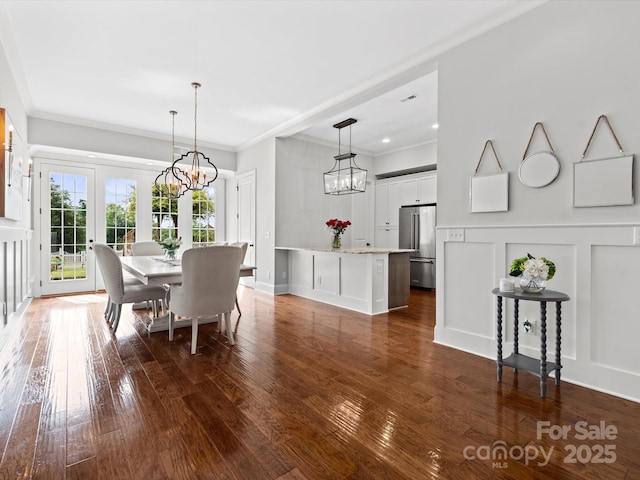 2521 Neely Store Rd, Rock Hill, SC 29730 - dining space with a chandelier, a decorative wall, dark wood-style flooring, ornamental molding, and a wainscoted wall