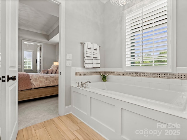 2521 Neely Store Rd, Rock Hill, SC 29730 - ensuite bathroom with radiator, a bath, plenty of natural light, wood finished floors, and crown molding