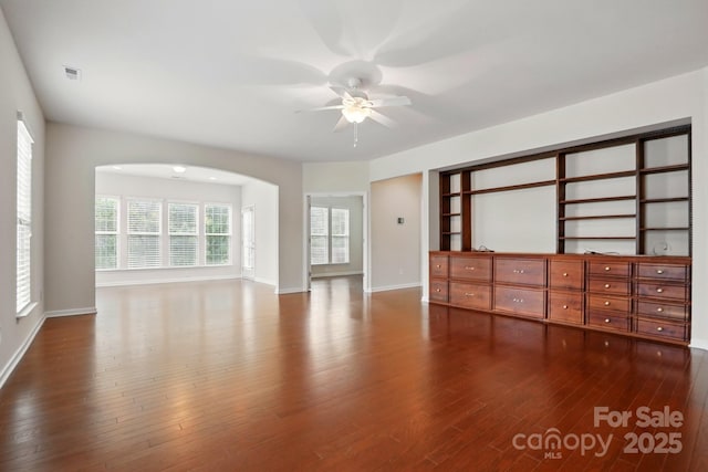 1030 Pinehurst Ln, Fort Mill, SC 29707 - empty room featuring arched walkways, a ceiling fan, dark wood finished floors, and baseboards