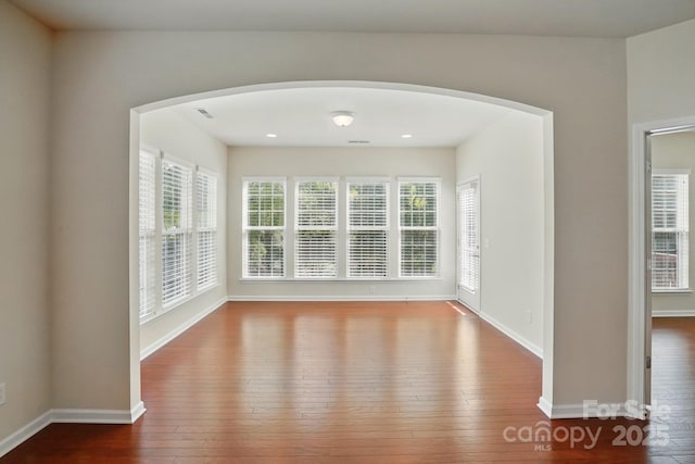 1030 Pinehurst Ln, Fort Mill, SC 29707 - spare room with hardwood / wood-style floors, arched walkways, and baseboards