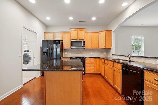 1030 Pinehurst Ln, Fort Mill, SC 29707 - kitchen with black appliances, a sink, washer / dryer, arched walkways, and dark wood-style floors