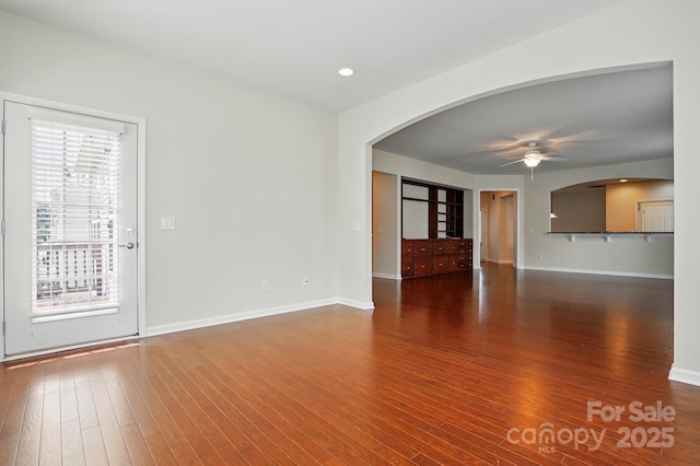 1030 Pinehurst Ln, Fort Mill, SC 29707 - unfurnished living room with arched walkways, ceiling fan, plenty of natural light, and baseboards