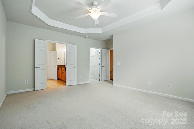 1030 Pinehurst Ln, Fort Mill, SC 29707 - unfurnished bedroom with a tray ceiling, light carpet, ornamental molding, a spacious closet, and baseboards