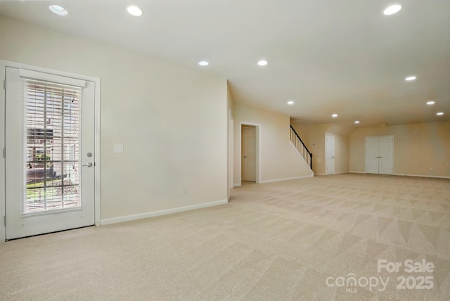 1030 Pinehurst Ln, Fort Mill, SC 29707 - unfurnished living room with light colored carpet, recessed lighting, healthy amount of natural light, stairs, and baseboards