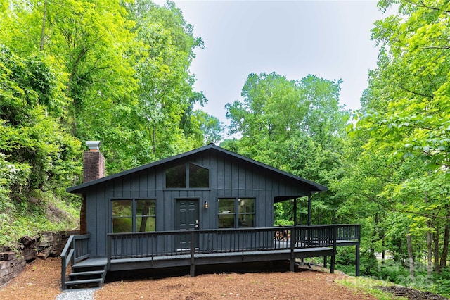 214 Hidden Creek Ln, Burnsville, NC 28714 - view of front facade featuring a chimney and a wooden deck