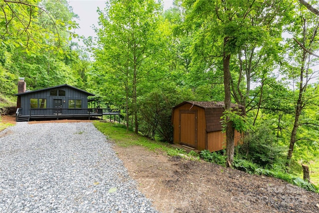 214 Hidden Creek Ln, Burnsville, NC 28714 - view of front facade with gravel driveway and a deck