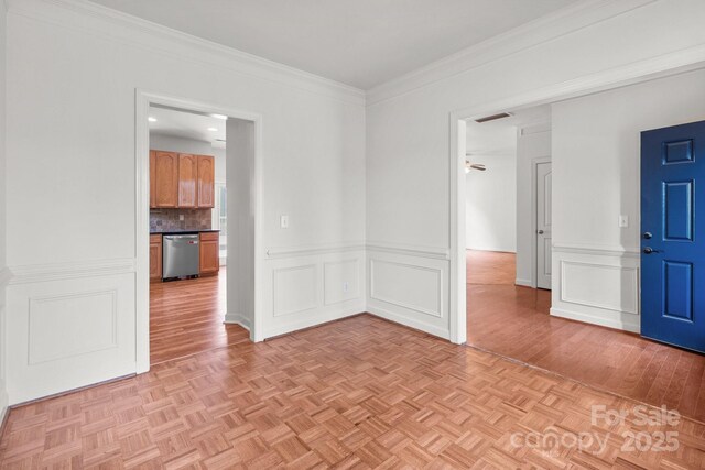 1534 Piney Church Rd, Concord, NC 28025 - empty room with crown molding, a wainscoted wall, parquet flooring, and a decorative wall