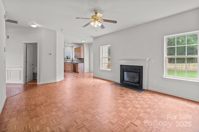 1534 Piney Church Rd, Concord, NC 28025 - unfurnished living room with ceiling fan, a fireplace with flush hearth, plenty of natural light, and baseboards