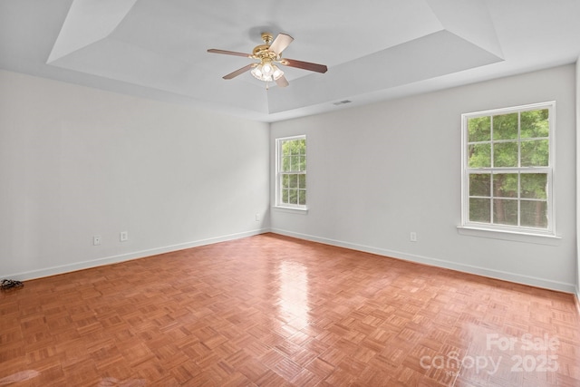 1534 Piney Church Rd, Concord, NC 28025 - unfurnished room with a tray ceiling, ceiling fan, and baseboards