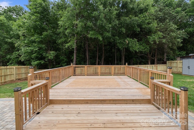 1534 Piney Church Rd, Concord, NC 28025 - wooden terrace featuring a fenced backyard, view of wooded area, and a storage unit