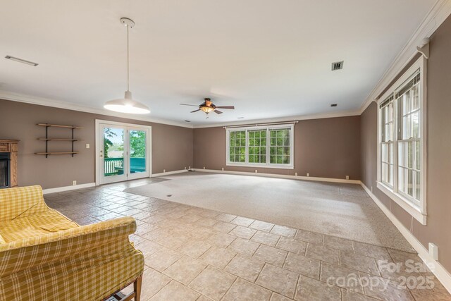 unfurnished living room featuring baseboards, ornamental molding, ceiling fan, stone finish flooring, and a fireplace