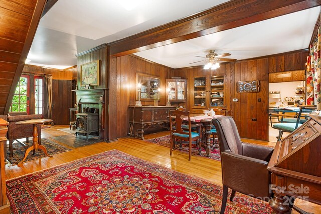1186 US-70 Hwy, Black Mountain, NC 28711 - office area with wood walls, a wood stove, a ceiling fan, and wood finished floors