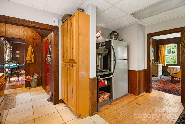 1186 US-70 Hwy, Black Mountain, NC 28711 - kitchen with freestanding refrigerator, wooden walls, a wainscoted wall, and light wood-type flooring