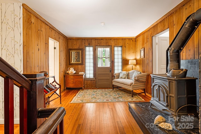 1186 US-70 Hwy, Black Mountain, NC 28711 - entryway with a wood stove, light wood-style floors, wood walls, and ornamental molding