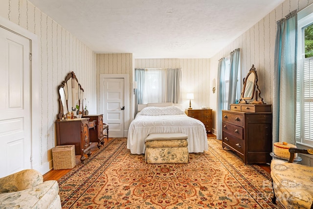 1186 US-70 Hwy, Black Mountain, NC 28711 - bedroom with wallpapered walls, light wood-type flooring, and baseboards