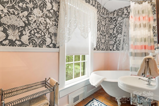 1186 US-70 Hwy, Black Mountain, NC 28711 - bathroom featuring wood finished floors, a soaking tub, curtained shower, and wallpapered walls