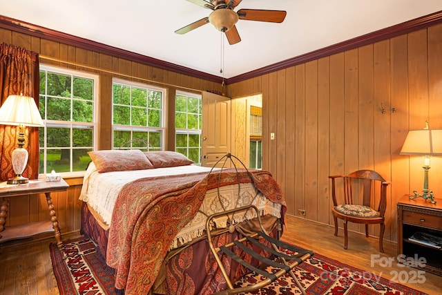 1186 US-70 Hwy, Black Mountain, NC 28711 - bedroom featuring hardwood / wood-style floors, crown molding, wood walls, and a ceiling fan