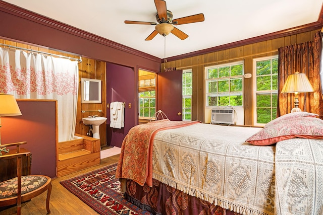 1186 US-70 Hwy, Black Mountain, NC 28711 - bedroom featuring hardwood / wood-style flooring, multiple windows, ornamental molding, a sink, and wood walls