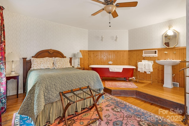 1186 US-70 Hwy, Black Mountain, NC 28711 - bedroom with wallpapered walls, wood finished floors, a wainscoted wall, and baseboards