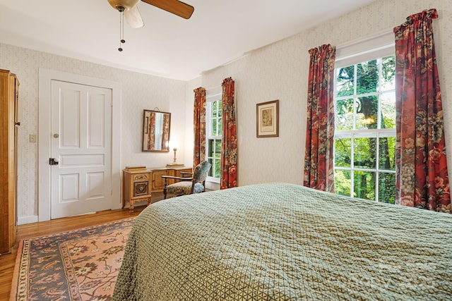 1186 US-70 Hwy, Black Mountain, NC 28711 - bedroom featuring wallpapered walls, wood finished floors, and a ceiling fan