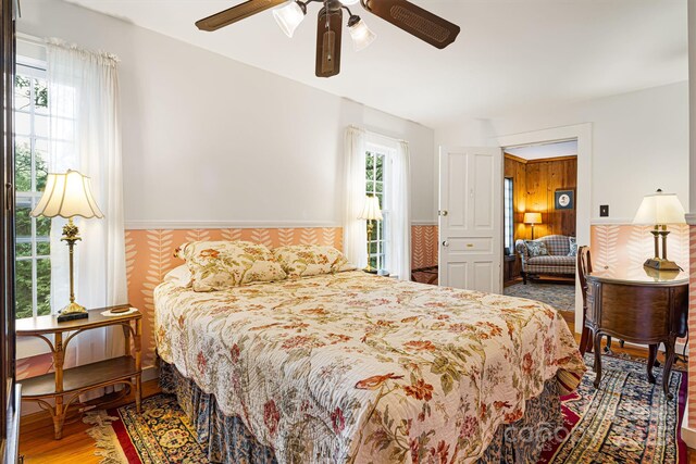 1186 US-70 Hwy, Black Mountain, NC 28711 - bedroom featuring wainscoting, wood finished floors, and ceiling fan