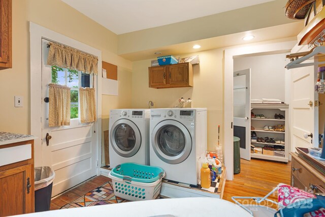 1186 US-70 Hwy, Black Mountain, NC 28711 - laundry room with washing machine and dryer, light wood-style floors, and cabinet space
