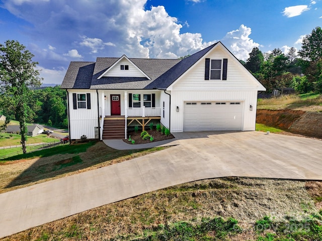 220 Pine Ridge Rd, Mars Hill, NC 28754 - modern inspired farmhouse with covered porch, driveway, a garage, roof with shingles, and board and batten siding