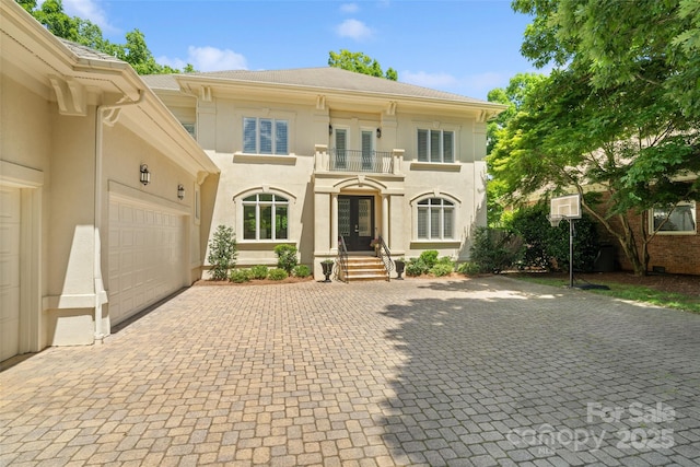 14515 Nolen Ln, Charlotte, NC 28277 - view of front facade featuring a balcony, decorative driveway, french doors, and stucco siding