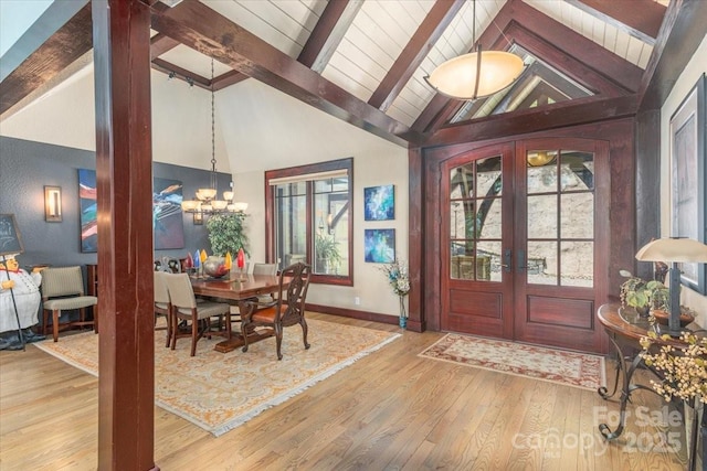 2461 Eagles Nest Rd, Waynesville, NC 28786 - foyer entrance featuring healthy amount of natural light, french doors, wood-type flooring, and a chandelier
