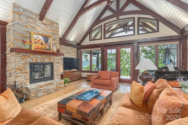 2461 Eagles Nest Rd, Waynesville, NC 28786 - living area featuring a stone fireplace, wood finished floors, high vaulted ceiling, and wood ceiling with exposed beams