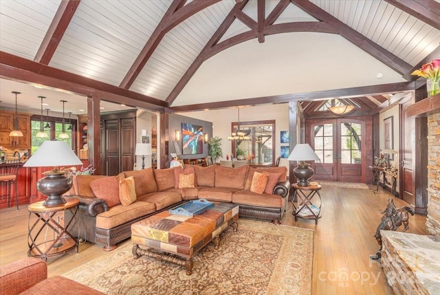 2461 Eagles Nest Rd, Waynesville, NC 28786 - living room with beamed ceiling, healthy amount of natural light, french doors, light wood-type flooring, and high vaulted ceiling